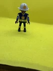 Playmobile Fire Fighter Figure In Blue Yellow Uniform W/a Red Shield Vg Used. Price: $7.00.